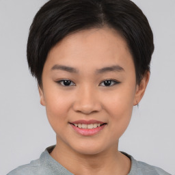 Joyful asian young-adult female with short  black hair and brown eyes