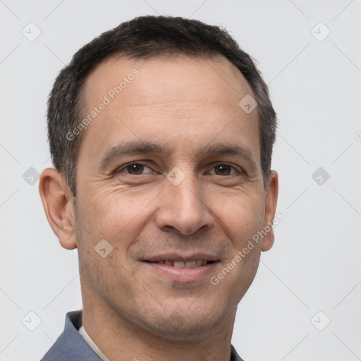 Joyful white adult male with short  brown hair and brown eyes