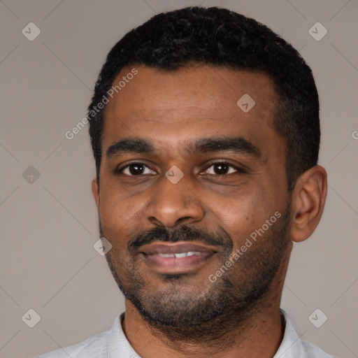Joyful latino young-adult male with short  black hair and brown eyes