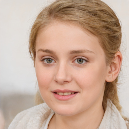 Joyful white young-adult female with medium  brown hair and blue eyes