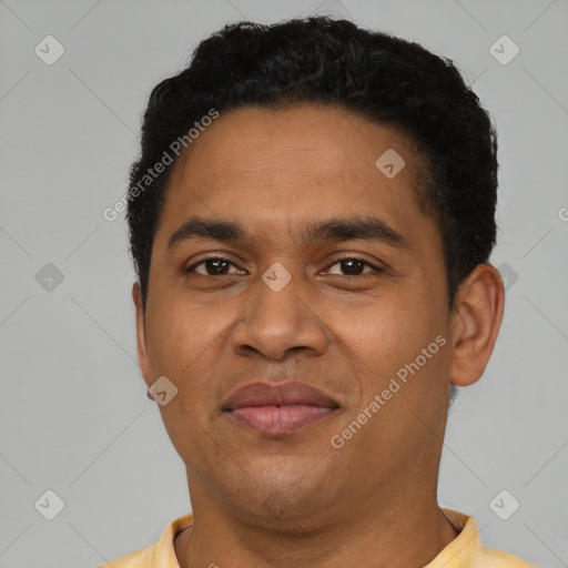 Joyful latino young-adult male with short  black hair and brown eyes