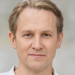 Joyful white adult male with short  brown hair and grey eyes