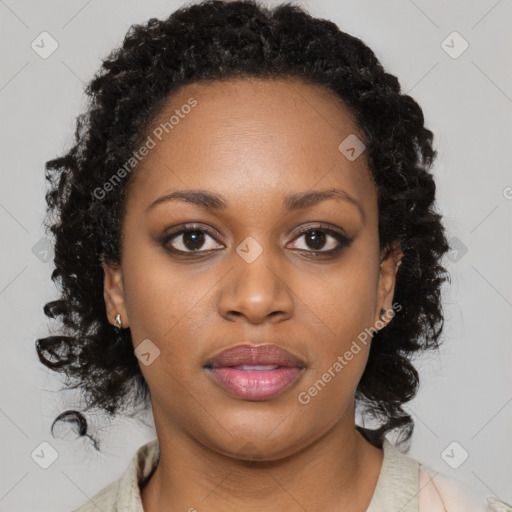 Joyful black young-adult female with long  brown hair and brown eyes