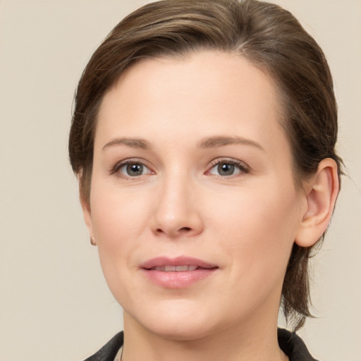 Joyful white young-adult female with medium  brown hair and grey eyes