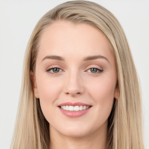 Joyful white young-adult female with long  brown hair and grey eyes