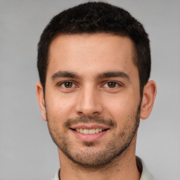 Joyful white young-adult male with short  brown hair and brown eyes