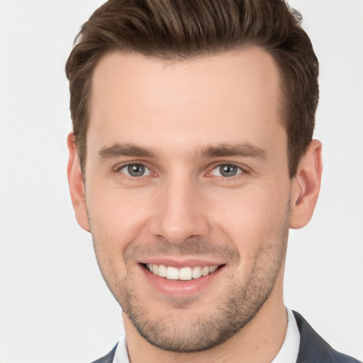 Joyful white young-adult male with short  brown hair and brown eyes