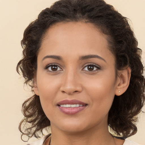 Joyful white young-adult female with long  brown hair and brown eyes