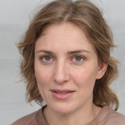 Joyful white young-adult female with medium  brown hair and blue eyes