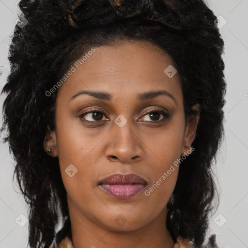 Joyful black young-adult female with long  brown hair and brown eyes