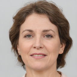 Joyful white adult female with medium  brown hair and brown eyes