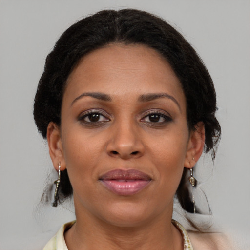 Joyful latino adult female with medium  brown hair and brown eyes