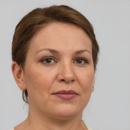 Joyful white adult female with medium  brown hair and brown eyes