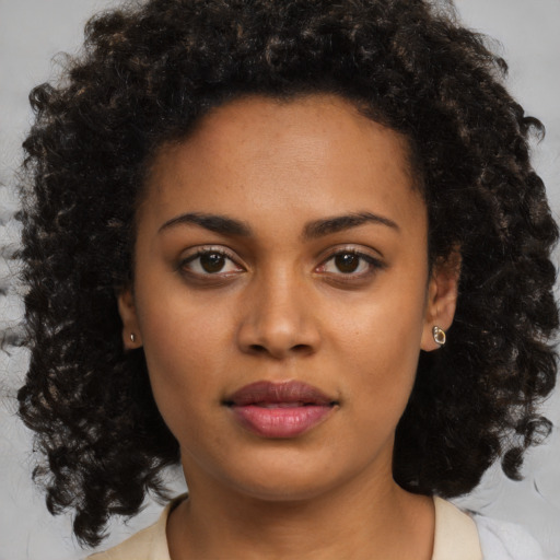 Neutral black young-adult female with medium  brown hair and brown eyes