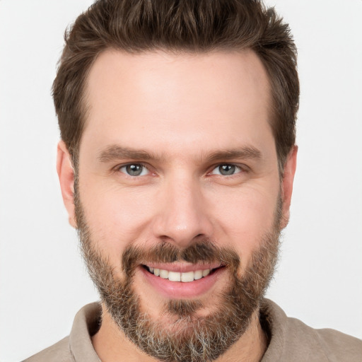 Joyful white young-adult male with short  brown hair and brown eyes