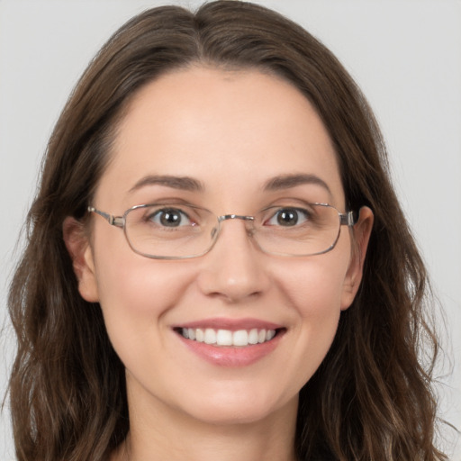 Joyful white young-adult female with long  brown hair and grey eyes