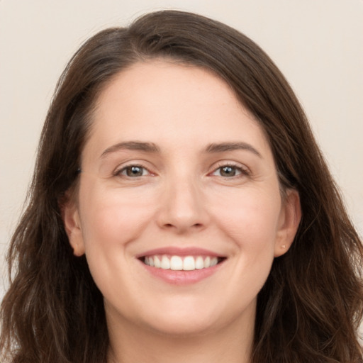 Joyful white young-adult female with long  brown hair and grey eyes