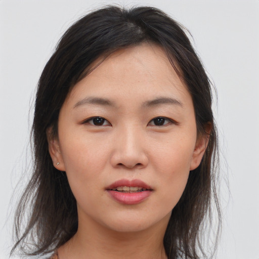 Joyful asian young-adult female with medium  brown hair and brown eyes