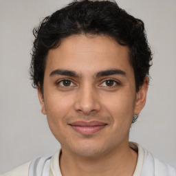 Joyful latino young-adult male with short  brown hair and brown eyes