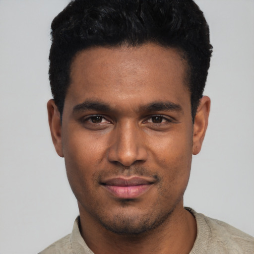 Joyful black young-adult male with short  black hair and brown eyes