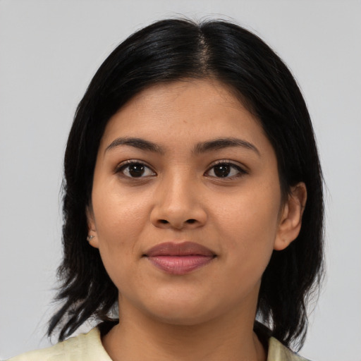 Joyful asian young-adult female with medium  black hair and brown eyes