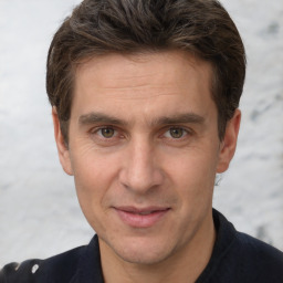 Joyful white adult male with short  brown hair and brown eyes