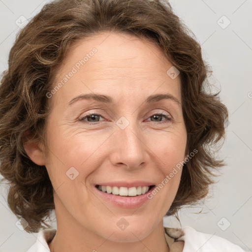 Joyful white adult female with medium  brown hair and green eyes