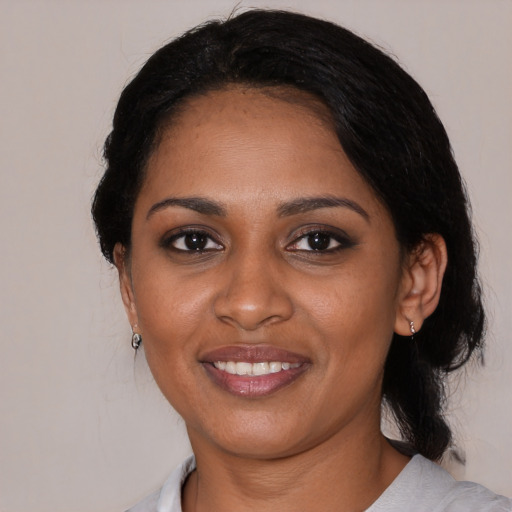 Joyful black young-adult female with medium  black hair and brown eyes