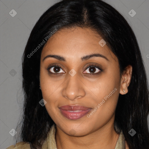 Joyful black young-adult female with long  brown hair and brown eyes