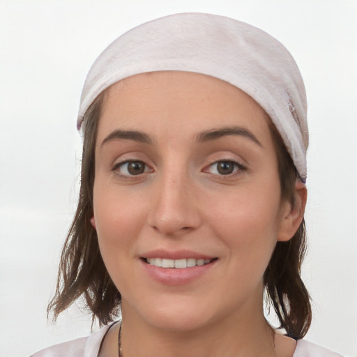 Joyful white young-adult female with medium  brown hair and grey eyes