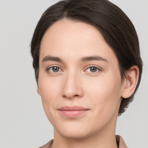 Joyful white young-adult female with medium  brown hair and brown eyes