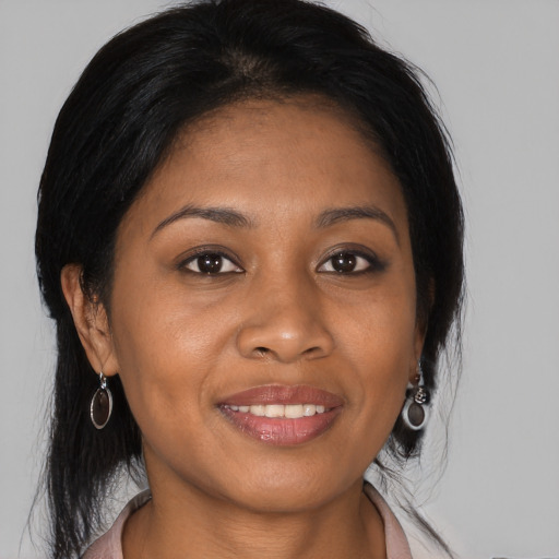 Joyful black young-adult female with medium  brown hair and brown eyes