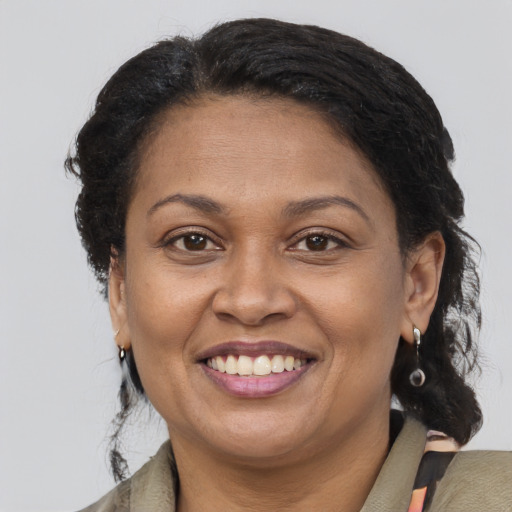 Joyful black adult female with medium  brown hair and brown eyes