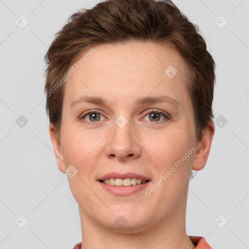 Joyful white young-adult female with short  brown hair and grey eyes