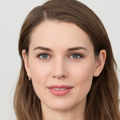 Joyful white young-adult female with long  brown hair and grey eyes