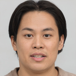 Joyful asian young-adult male with short  brown hair and brown eyes