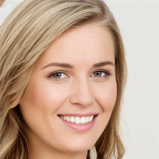 Joyful white young-adult female with long  brown hair and blue eyes