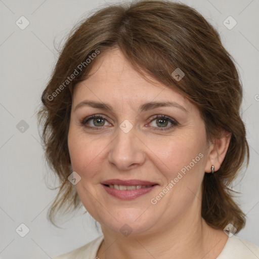 Joyful white adult female with medium  brown hair and grey eyes