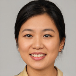 Joyful asian young-adult female with medium  brown hair and brown eyes