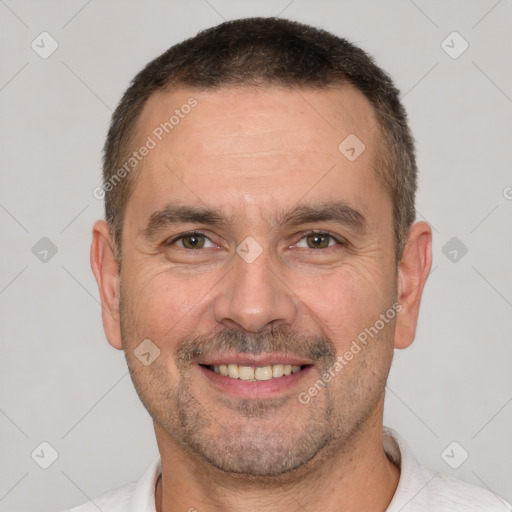 Joyful white adult male with short  brown hair and brown eyes