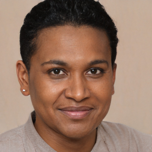 Joyful black young-adult male with short  brown hair and brown eyes