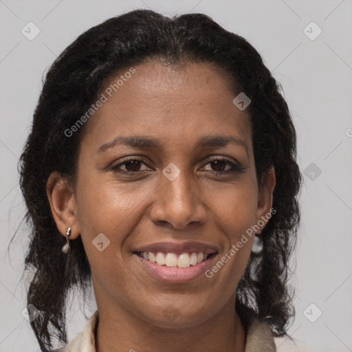 Joyful black adult female with medium  brown hair and brown eyes