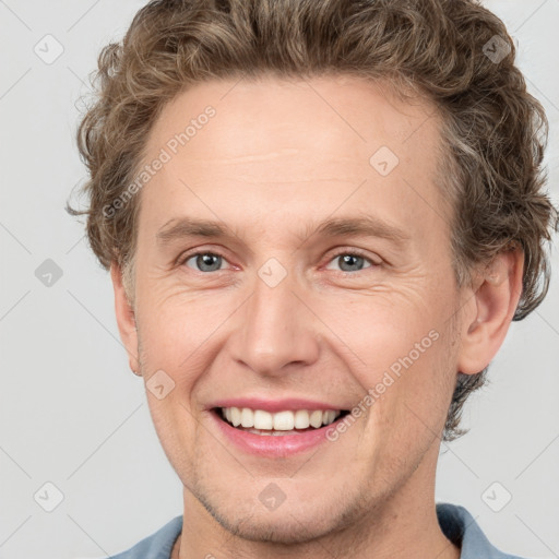 Joyful white adult male with short  brown hair and grey eyes