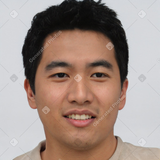 Joyful asian young-adult male with short  black hair and brown eyes