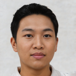 Joyful asian young-adult male with short  black hair and brown eyes