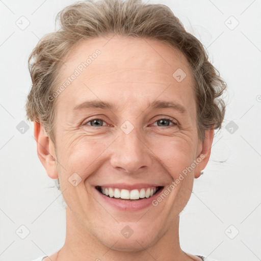 Joyful white adult male with short  brown hair and grey eyes