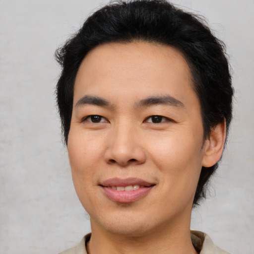 Joyful asian young-adult male with short  brown hair and brown eyes