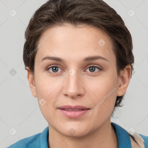 Joyful white young-adult female with short  brown hair and grey eyes