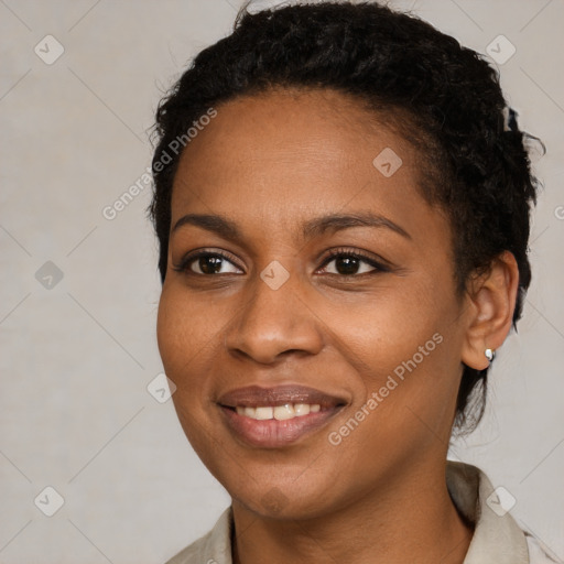 Joyful black young-adult female with short  black hair and brown eyes