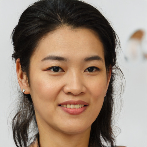 Joyful asian young-adult female with medium  brown hair and brown eyes